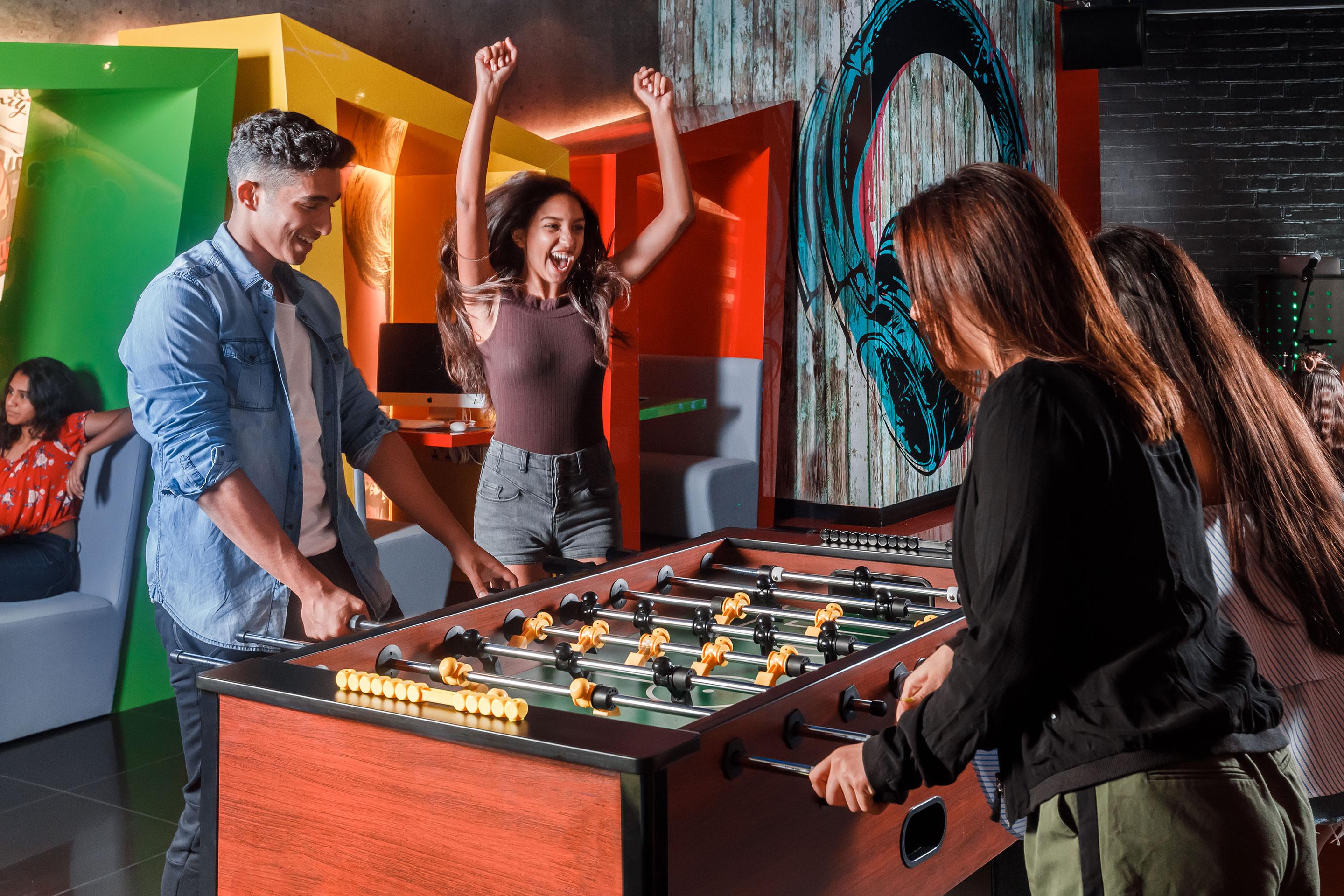 The Atlantis, The Palm Kids Club Teen Playing Foosball