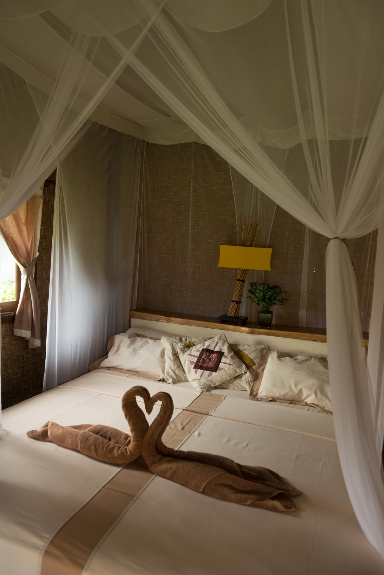 Image the Cosy Feeling of Curling Up on This Mosquito Net Covered Bed After a Long Day of Holiday fun 